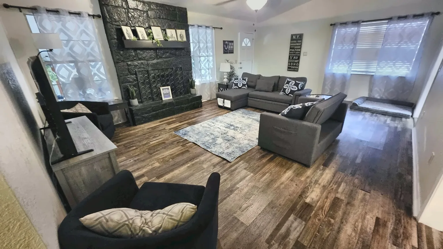 Main living room at The Space Place with sectional seating and a stone fireplace