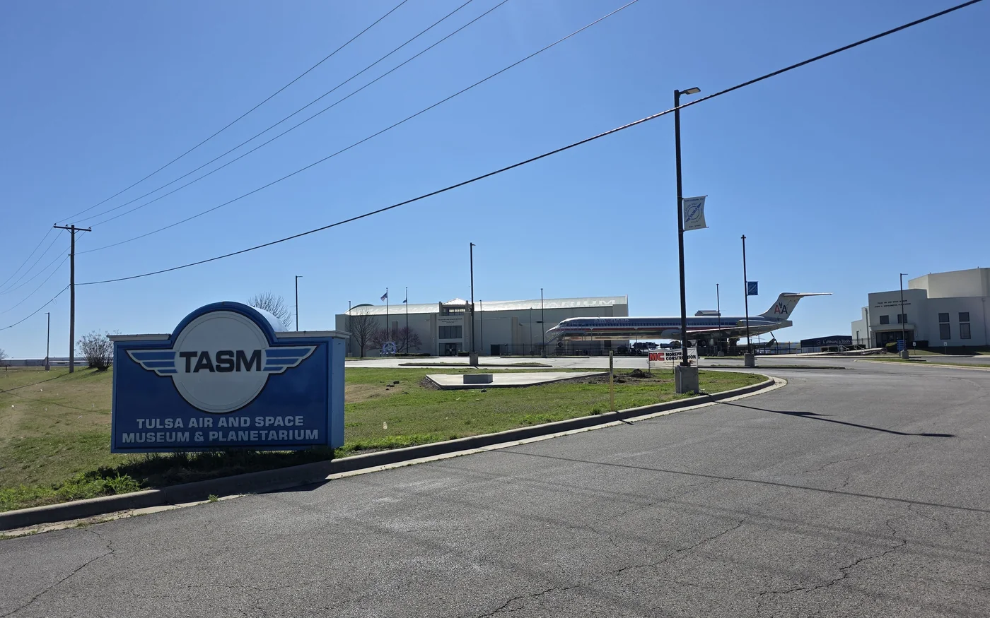 Tulsa Air and Space Museum exterior sign with aircraft outside
